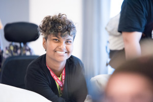 A NCIL Member smiles at the camera during the 2015 Annual Conference on Independent Living