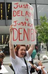 Justice Delayed Is Justice Denied sign at the 2012 Conference
