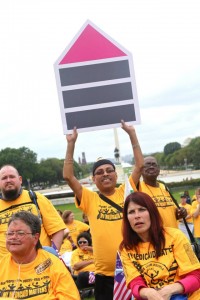 Advocate Holds Fair Housing Symbol at 2011 My Medicaid Matters Rally
