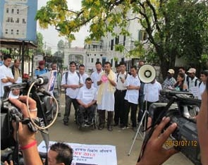Representatives of CIL Kathmandu speak at an outdoor gathering with video cameras