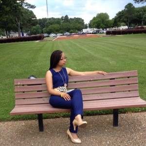 Keri Gray Sitting on a bench looking sharp