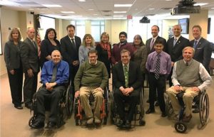 Sixteen people gather for a group photo at the Stakeholders’ Forum on Accessible Parking and Disabled Placard Abuse, December 6, 2017 at U.S. Access Board offices