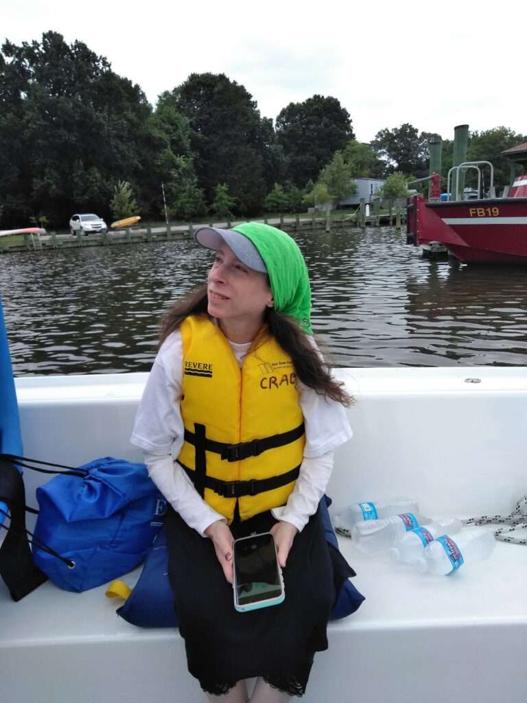 Sheryl engages in conversation on a boat during a NCIL staff retreat.